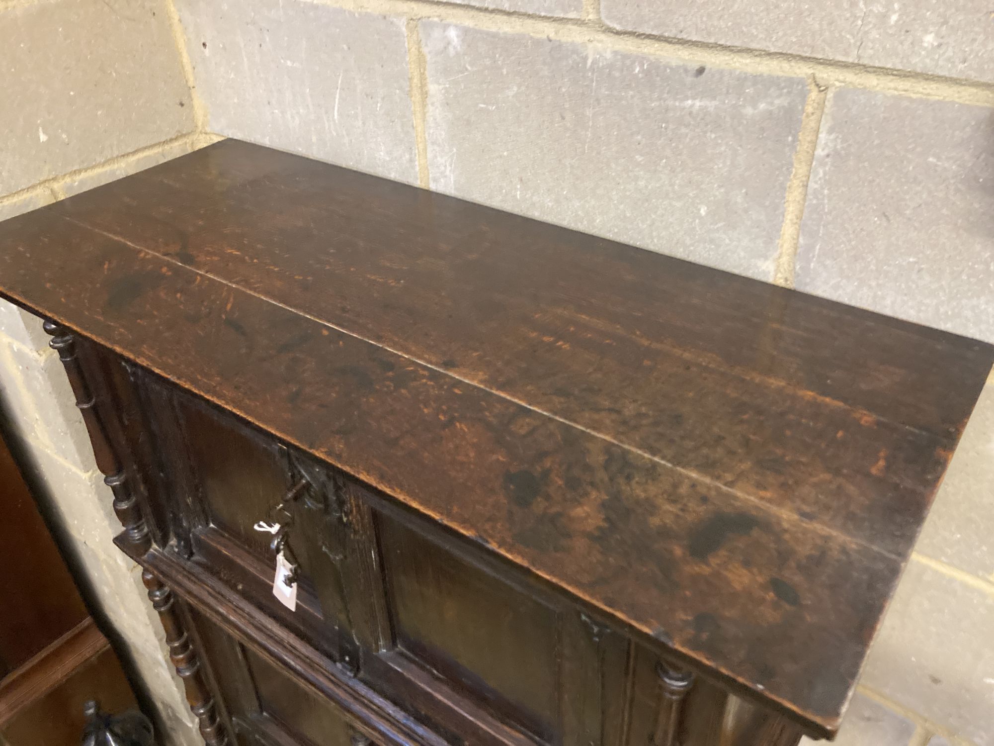 A 17th century style oak cupboard, width 100cm depth 42cm height 140cm